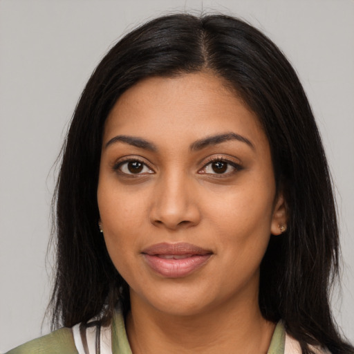 Joyful latino young-adult female with long  black hair and brown eyes