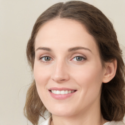 Joyful white young-adult female with medium  brown hair and green eyes