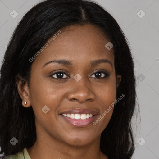 Joyful black young-adult female with long  brown hair and brown eyes