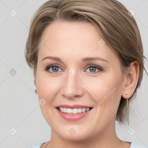 Joyful white young-adult female with medium  brown hair and blue eyes