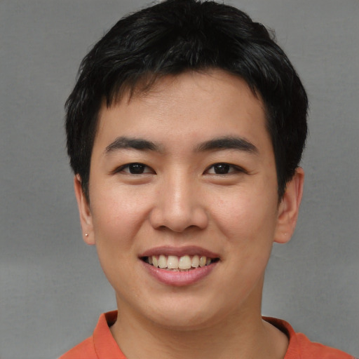 Joyful asian young-adult male with short  brown hair and brown eyes
