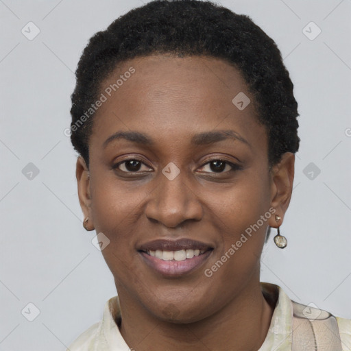 Joyful black young-adult female with short  black hair and brown eyes