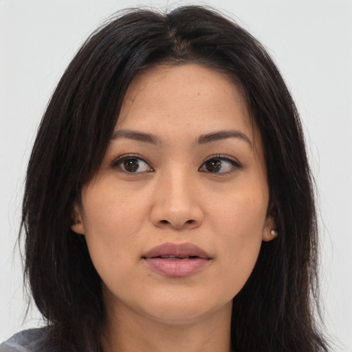 Joyful asian young-adult female with long  brown hair and brown eyes