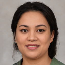 Joyful latino young-adult female with medium  brown hair and brown eyes