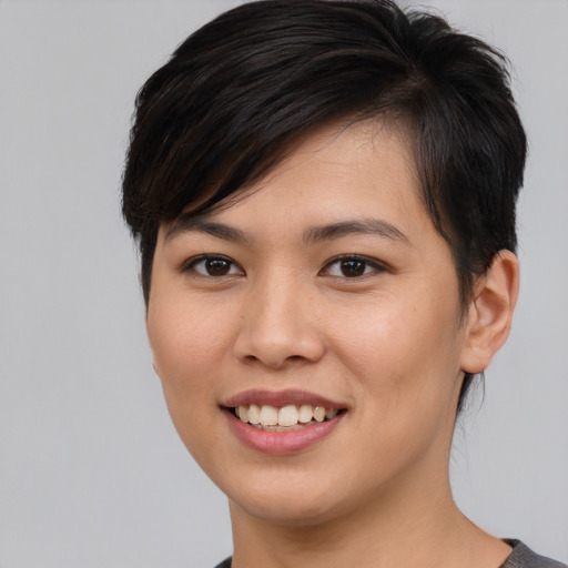 Joyful asian young-adult female with short  brown hair and brown eyes
