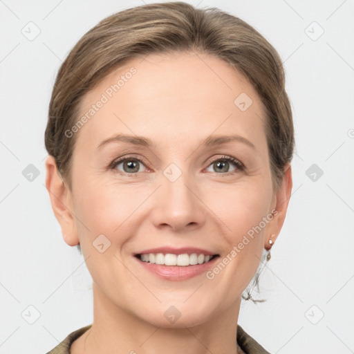 Joyful white adult female with medium  brown hair and grey eyes