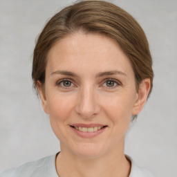 Joyful white young-adult female with short  brown hair and grey eyes