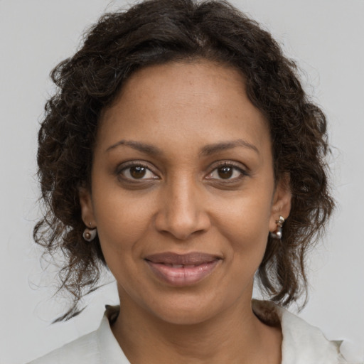 Joyful black young-adult female with medium  brown hair and brown eyes