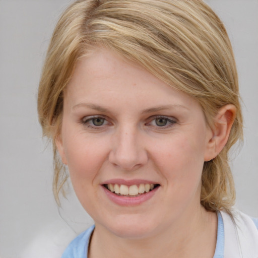 Joyful white young-adult female with medium  brown hair and blue eyes