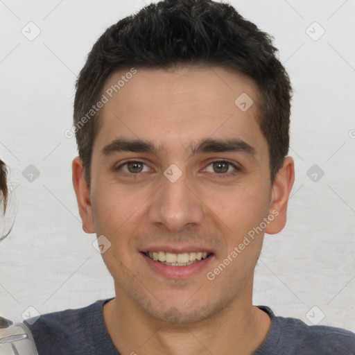 Joyful white young-adult male with short  black hair and brown eyes