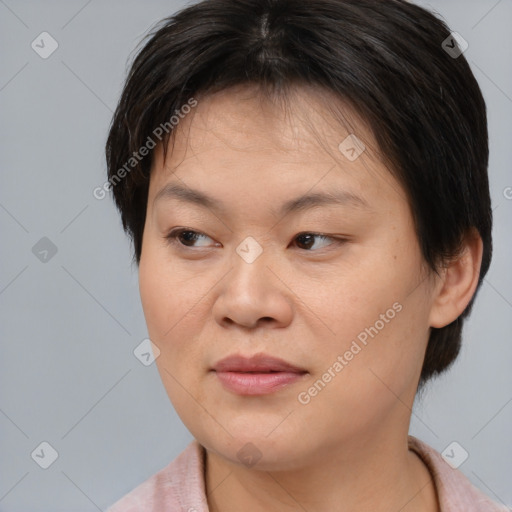 Joyful asian young-adult female with medium  brown hair and brown eyes