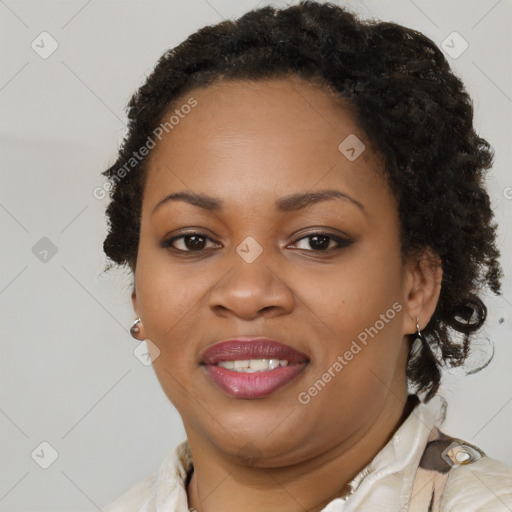 Joyful black adult female with short  brown hair and brown eyes