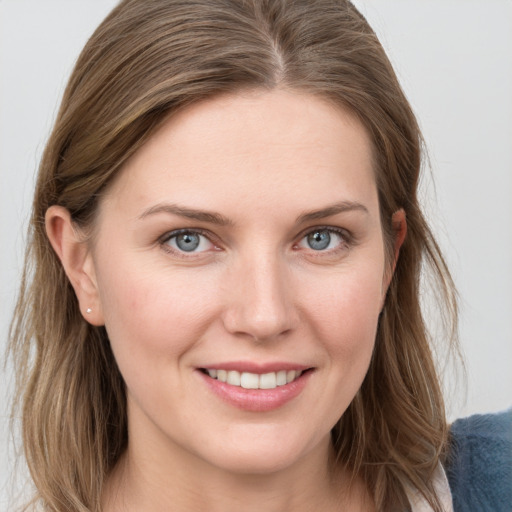 Joyful white young-adult female with long  brown hair and grey eyes