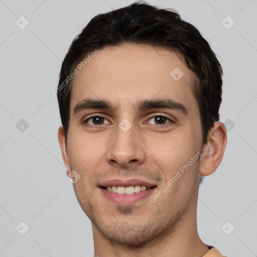 Joyful white young-adult male with short  brown hair and brown eyes