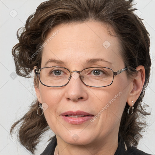 Joyful white adult female with medium  brown hair and blue eyes