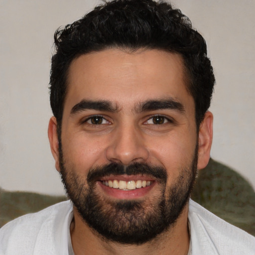 Joyful white young-adult male with short  black hair and brown eyes