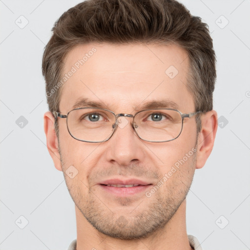 Joyful white adult male with short  brown hair and grey eyes