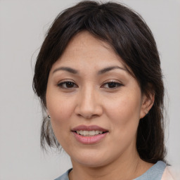 Joyful asian adult female with medium  brown hair and brown eyes