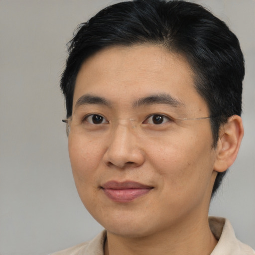 Joyful asian young-adult male with short  brown hair and brown eyes