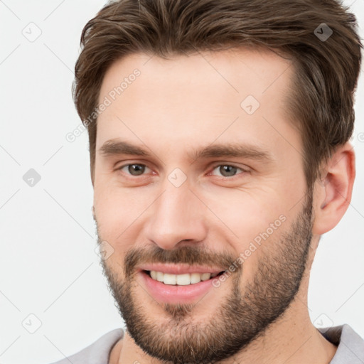 Joyful white young-adult male with short  brown hair and brown eyes