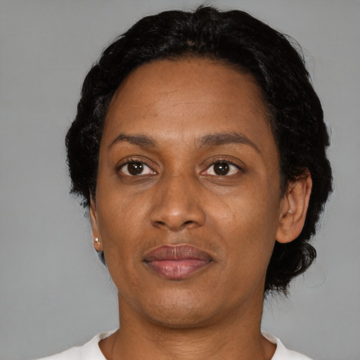 Joyful black adult female with short  brown hair and brown eyes