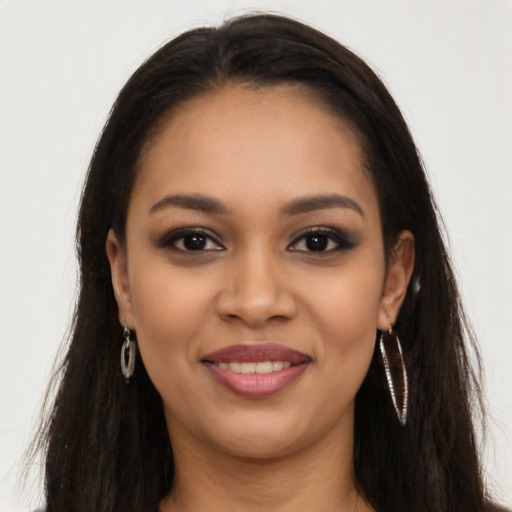 Joyful latino young-adult female with long  brown hair and brown eyes