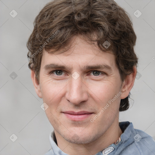 Joyful white adult male with short  brown hair and grey eyes