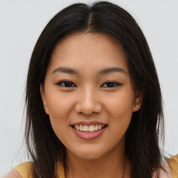 Joyful asian young-adult female with long  brown hair and brown eyes