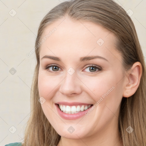 Joyful white young-adult female with long  brown hair and grey eyes