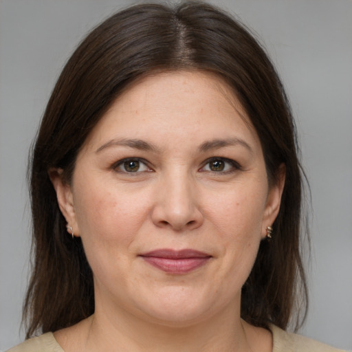 Joyful white adult female with medium  brown hair and brown eyes