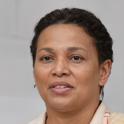 Joyful latino adult female with short  brown hair and brown eyes