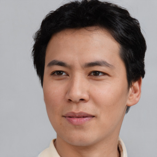 Joyful asian young-adult male with short  brown hair and brown eyes