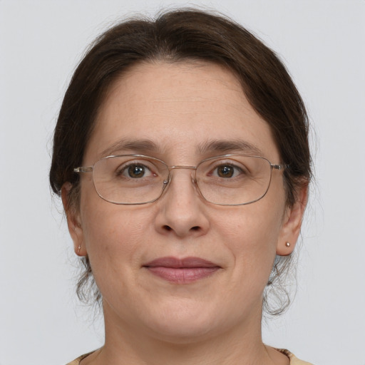 Joyful white adult female with medium  brown hair and grey eyes