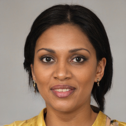 Joyful black young-adult female with medium  black hair and brown eyes