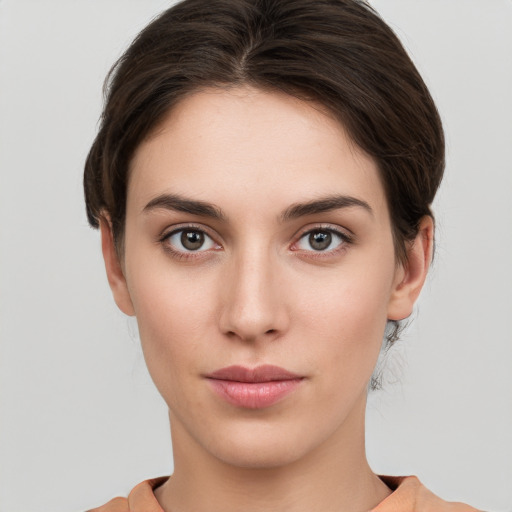 Neutral white young-adult female with short  brown hair and brown eyes