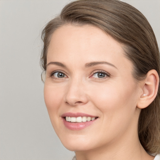 Joyful white young-adult female with long  brown hair and brown eyes