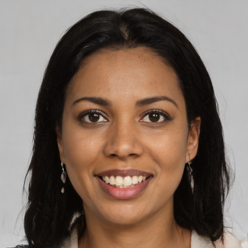 Joyful black young-adult female with medium  black hair and brown eyes