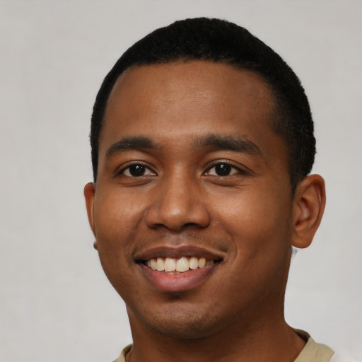 Joyful black young-adult male with short  black hair and brown eyes