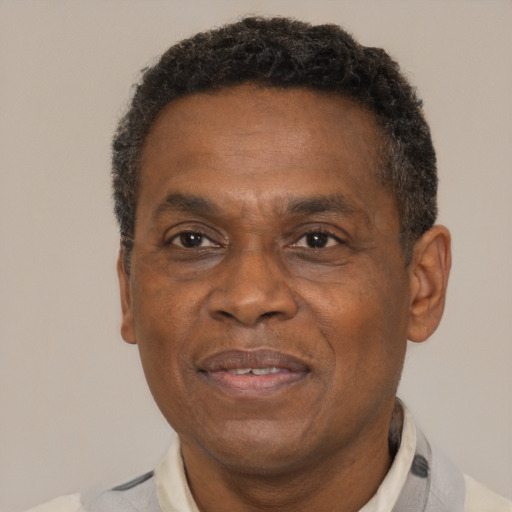 Joyful black adult male with short  brown hair and brown eyes