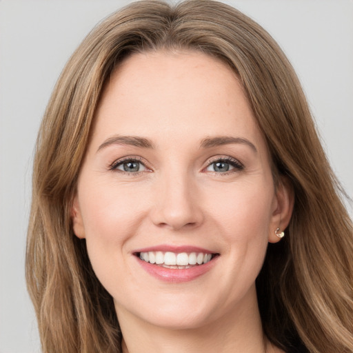 Joyful white young-adult female with long  brown hair and green eyes