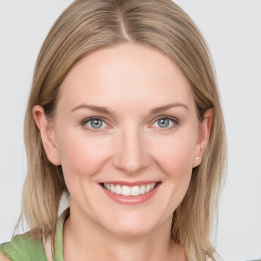 Joyful white young-adult female with medium  brown hair and blue eyes