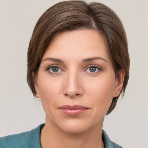 Joyful white young-adult female with medium  brown hair and grey eyes