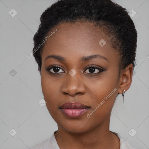 Joyful black young-adult female with short  black hair and brown eyes