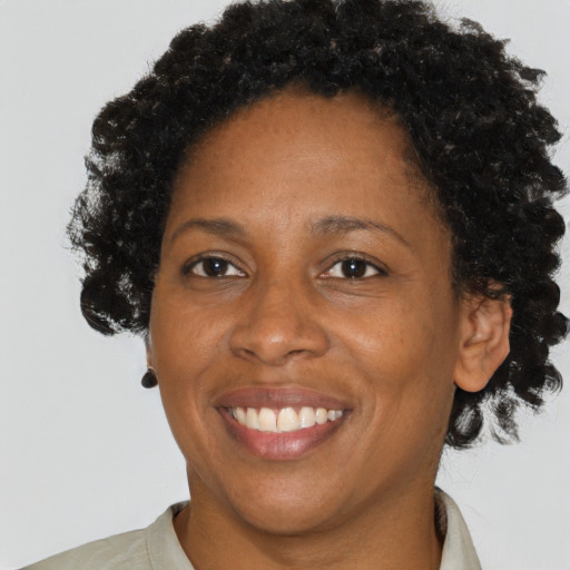 Joyful black adult female with short  brown hair and brown eyes