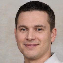 Joyful white young-adult male with short  brown hair and brown eyes