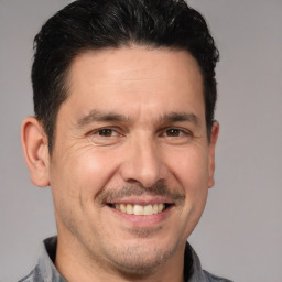 Joyful white adult male with short  brown hair and brown eyes