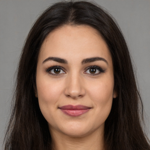 Joyful white young-adult female with long  brown hair and brown eyes