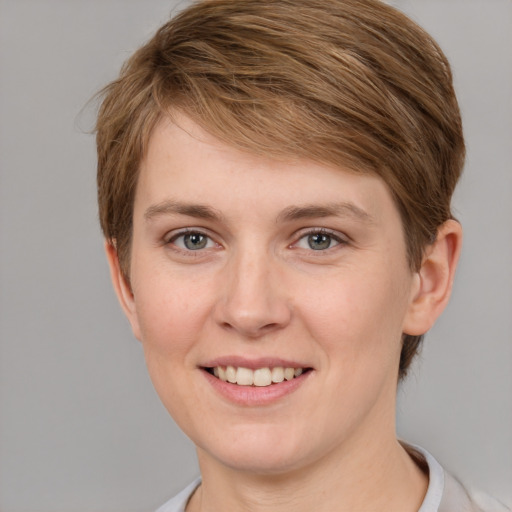 Joyful white young-adult female with short  brown hair and grey eyes