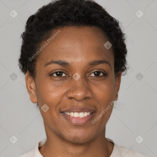 Joyful black adult female with short  brown hair and brown eyes