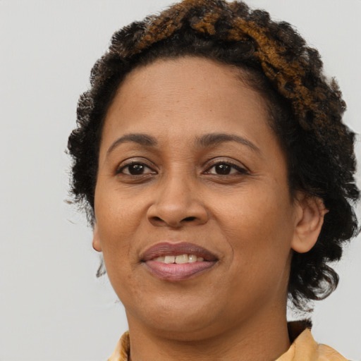 Joyful black adult female with short  brown hair and brown eyes